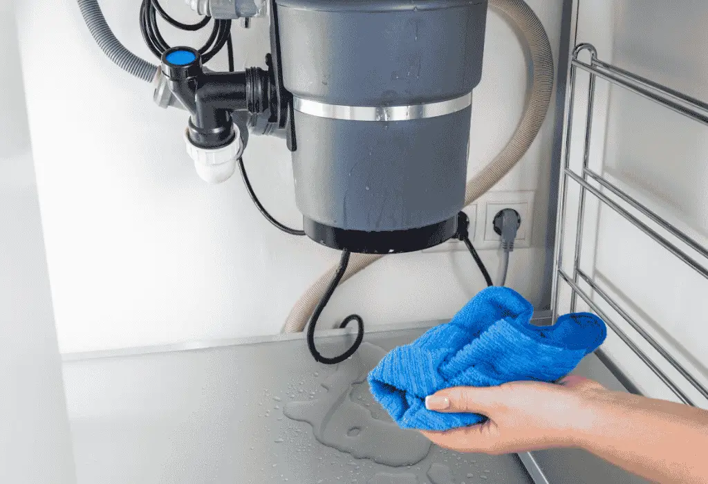 Leaking garbage disposal under a kitchen sink