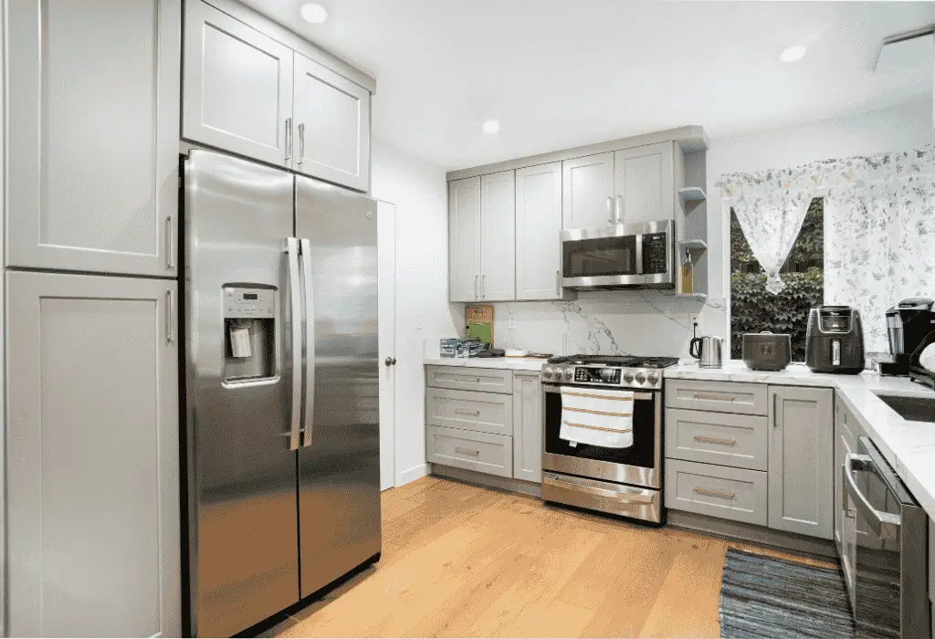 Clean kitchen with gas stove and household appliances