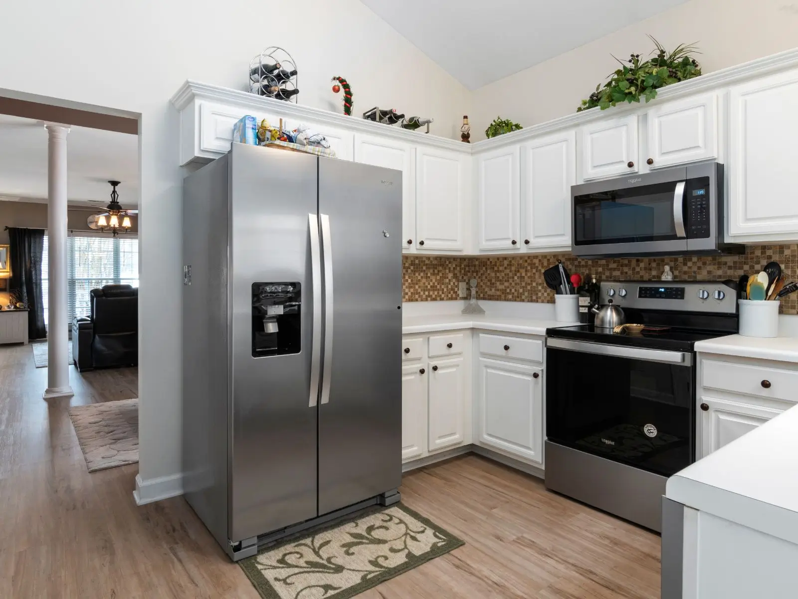 Stainless steel refrigerator installed in a bright residential kitchen