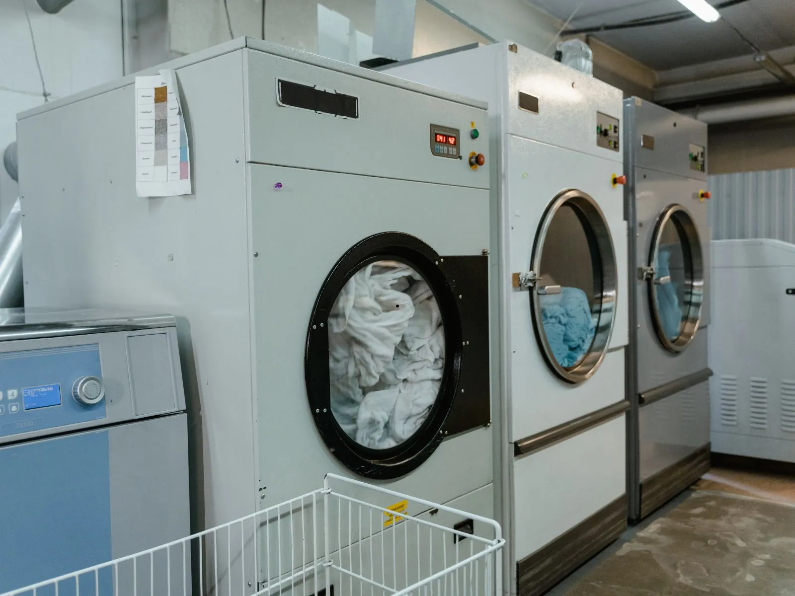 Multiple front-load washing machines in a commercial laundry setting